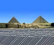 an array of solar panels with Giza's Sphinx and pyramids in background
